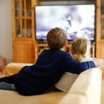 Cute Little Toddler Girl And School Kid Boy Watching Animal Movi